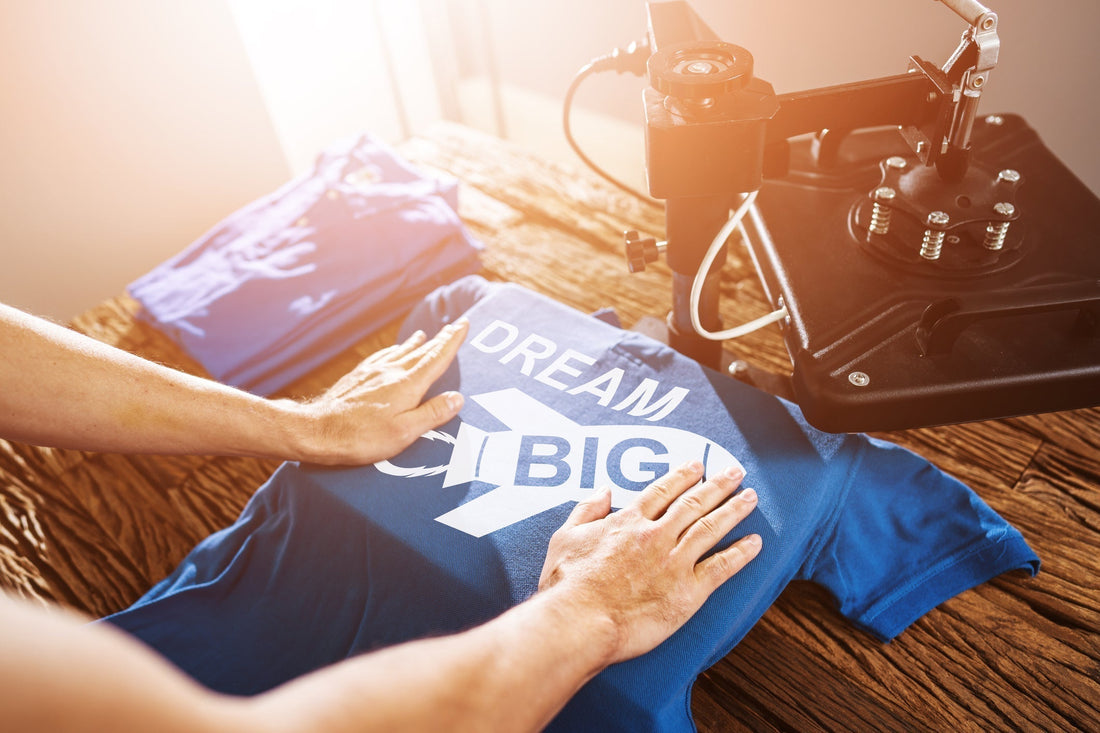 Person heat pressing DTF print onto blue polo shirt